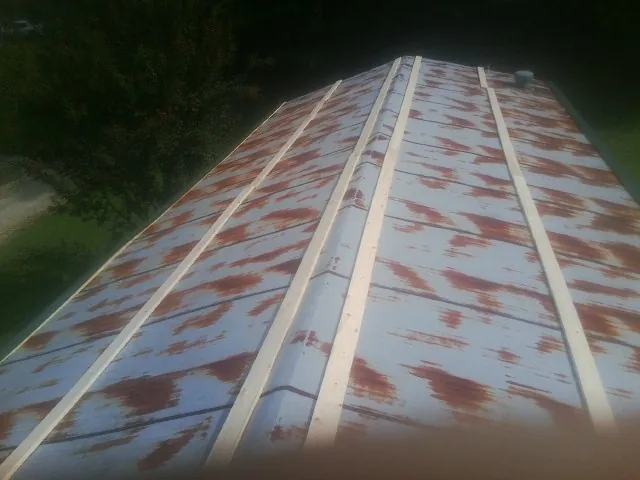 Rusted metal roof panels with new wood purlins before replacement — Storm Damage Roof Repair in Pooler by Roofing Brothers