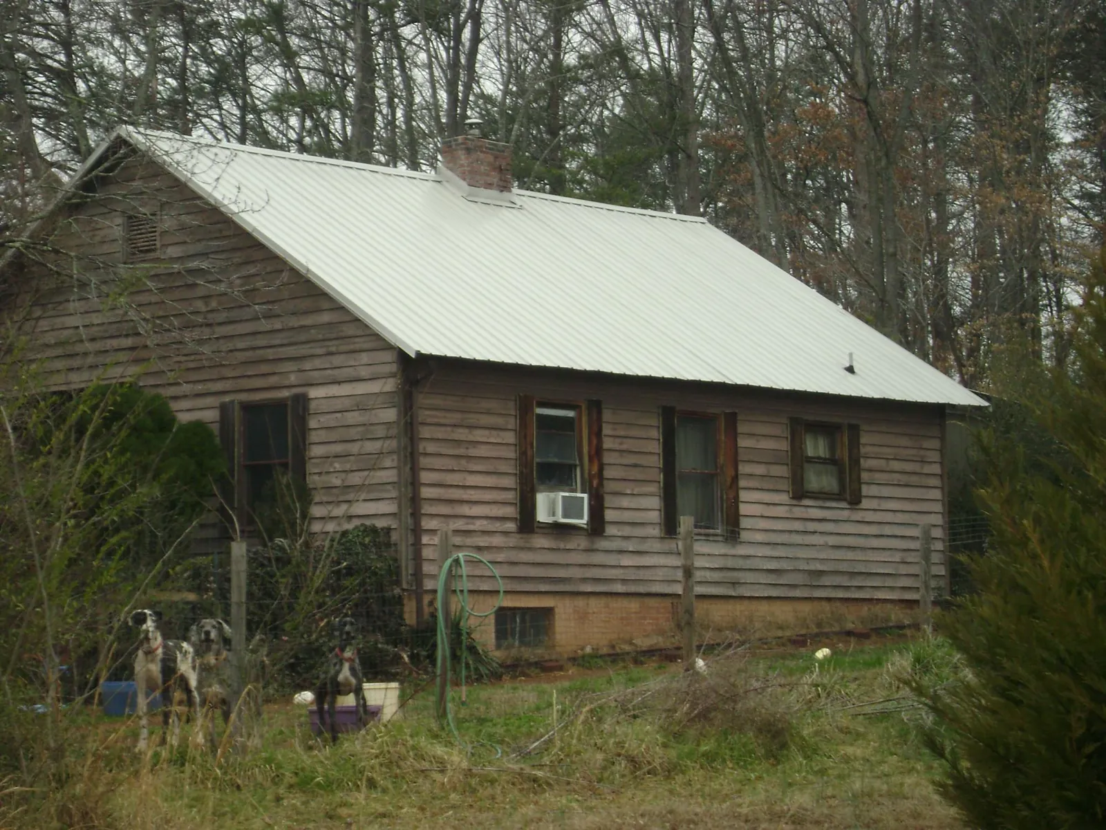 White metal roof on an old wood sided farmhouse, from a Metal Roof Installation job in Pooler